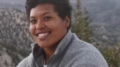 Image of a person with mountain scenery in background